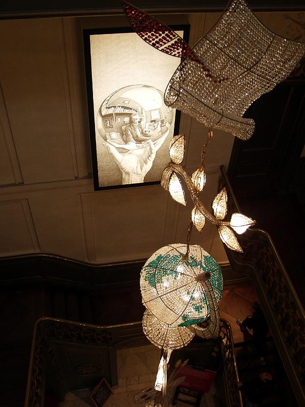 P2205714.jpg - This is the chandelier in the Main Hall at the Escher Museum.  You can see a blowup of one of his famous pieces on the wall.