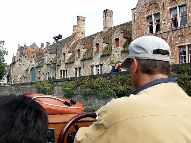 P7036567.jpg - Here is our captain with some medievel homes in the background.